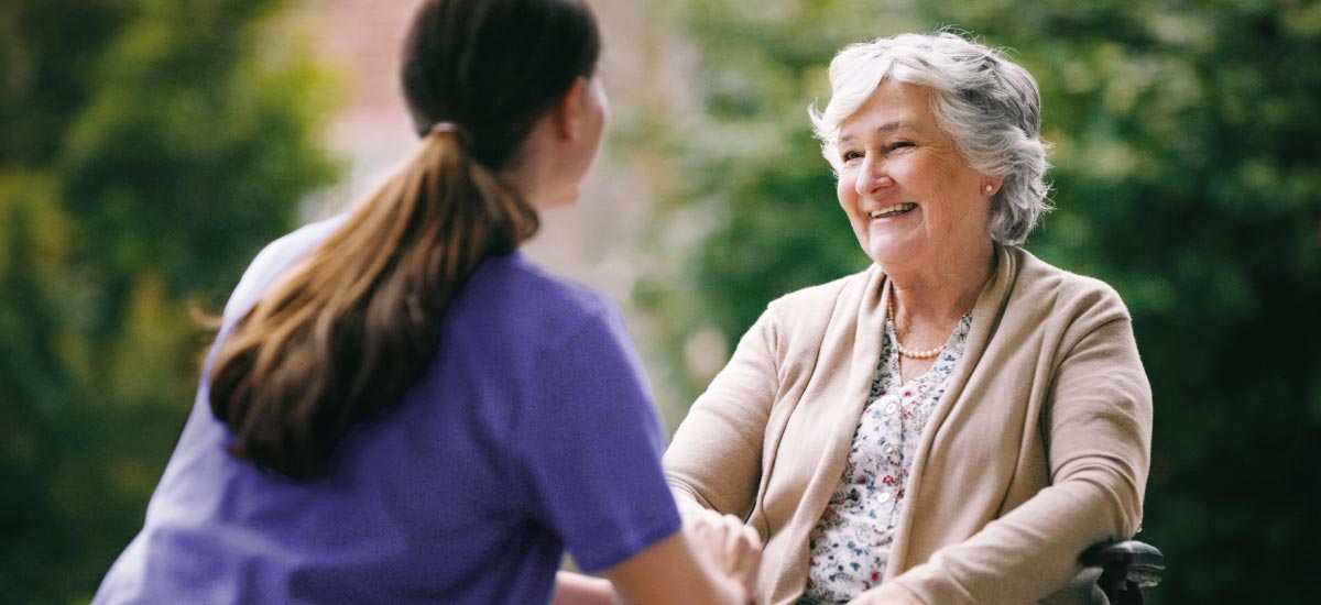 Carer and resident chatting