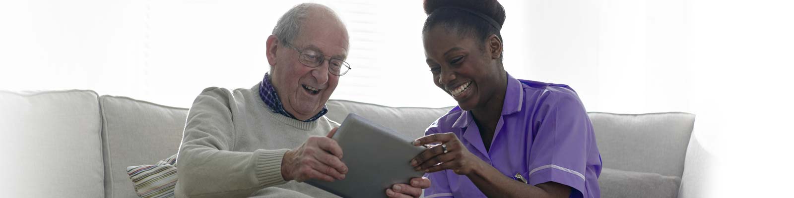 Service User and Carer talking on couch