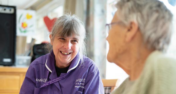 Carer and resident talking and laughing