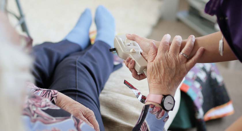 Staff helping a service user with mobility