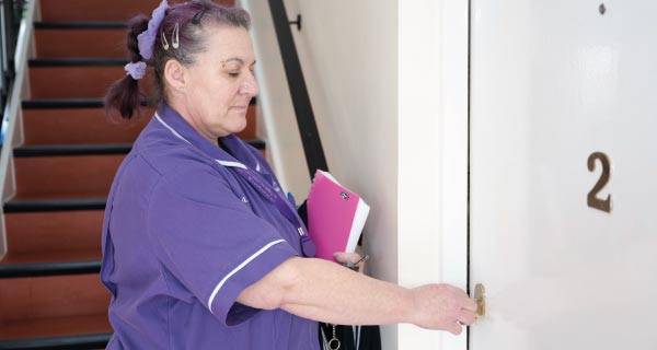 Carer entering a home