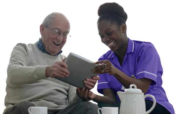 Carer sitting next to home care client laughing