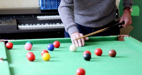 Resident playing a game of pool