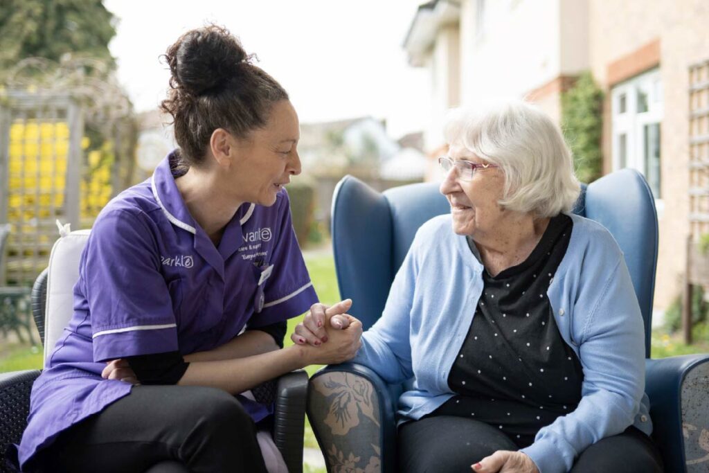 Avante Care and Resident sitting in the garden and talking