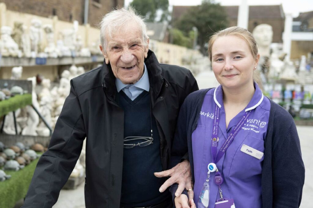Resident and Avante Care Worker at a garden centre smiling