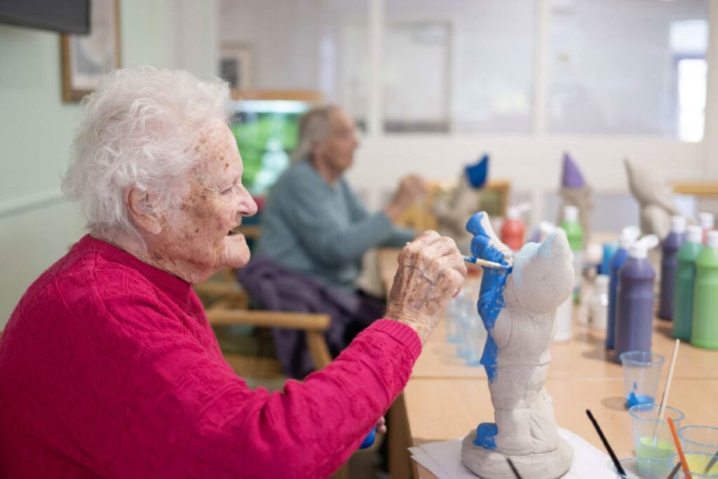 Residents painting garden gnomes with bright colours
