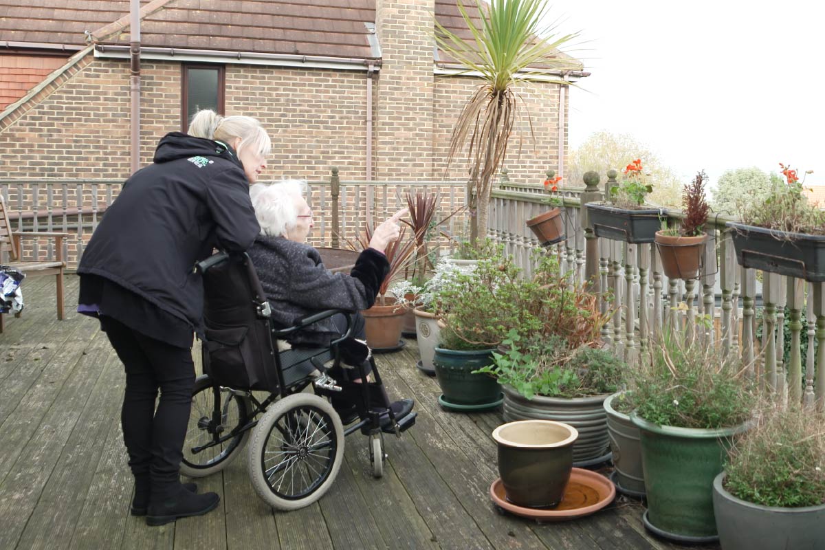Service User and Home Carer in the garden admiring the view