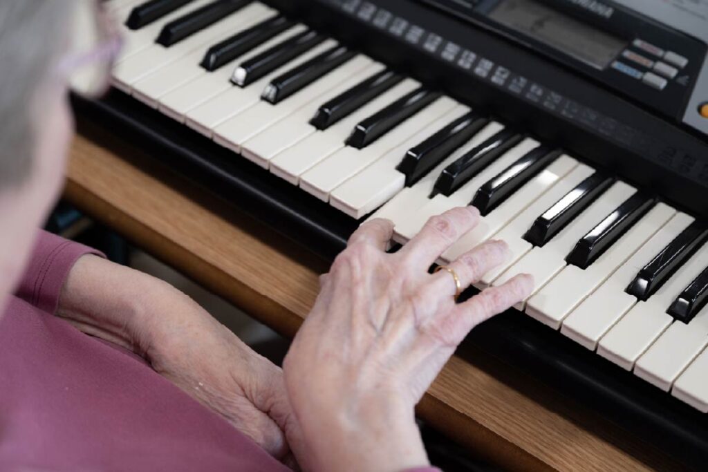 A resident playing on a electronic keyboard